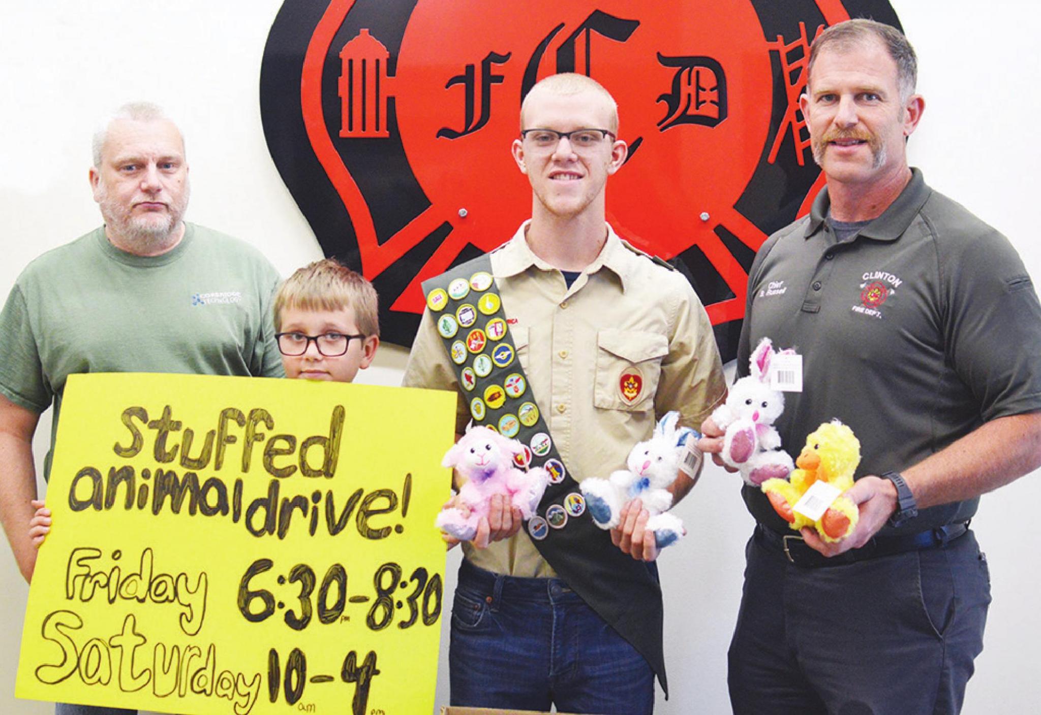 Inside the Clinton Fire Department’s fire station are, from left, James Corbridge, Drezden Corbridge, Eagle Scout candidate Joseph Corbridge, and Fire Chief Brett Russell.
