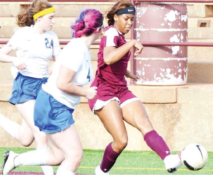 CDN | Collin Wieder                      Clinton senior defender Aleisha Hester, right, pushes a pass by two Classen SAS defenders. Hester and the Lady Reds won their fourth district game of the season Tuesday, blasting the Lady Comets, 10-0.