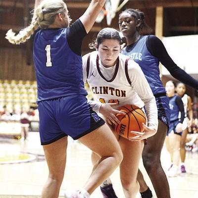 Clinton’s Brooklyn Aston drives between two Newcastle players during the Lady Reds’ home game Thursday against the Lady Racers. CDN | Sam Goodwyn Clinton’s Brooklyn Aston drives between two Newcastle players during the Lady Reds’ home game Thursday against the Lady Racers. CDN | Sam Goodwyn