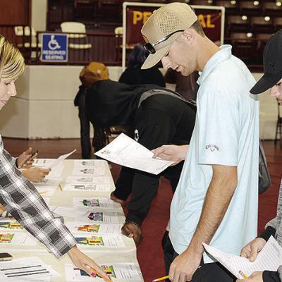 From left, realtor Shea Meget goes over house prices Thursday with seniors Craig Hunter and Christopher Price at the CHS Reality Check. CDN | Michael Maresh From left, realtor Shea Meget goes over house prices Thursday with seniors Craig Hunter and Christopher Price at the CHS Reality Check. CDN | Michael Maresh