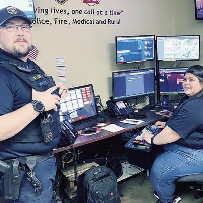 Clinton Police Officer and SRO Andrew Wilson, left, shares information with dispatcher Victoria Luna. CDN | Michael Maresh Clinton Police Officer and SRO Andrew Wilson, left, shares information with dispatcher Victoria Luna. CDN | Michael Maresh