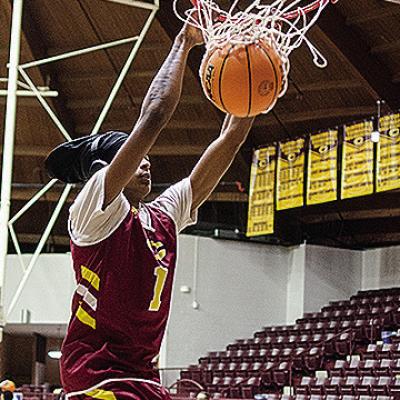 Clinton’s DJ Lister dunks the ball as he warms up for practice in the Tornado Dome. CDN | Sam Goodwyn