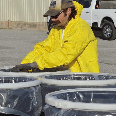 Cody Dillard disposes of several gallons of expired pesticide chemicals for disposal Thursday morning at the Custer County Fairgrounds. CDN | Micah Ashcraft