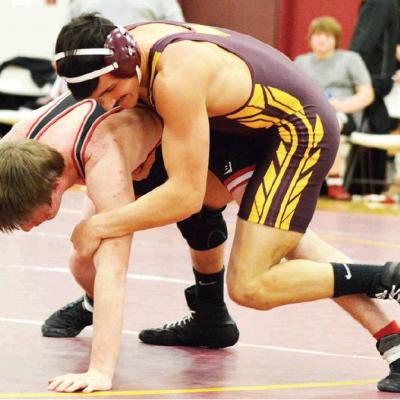 CDN | Collin Wieder Clinton senior wrestler Jaime Mitchell tries to get his Geary opponent back down on the mat during a dual earlier this year. Mitchell won his 10th match of the year in the Reds’ 64-18 win over Woodward Tuesda Reds blowout Boomers on road