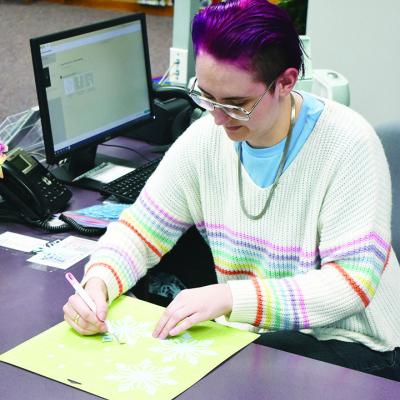 Assistant Library Manager Justin Anderson makes snowflake decorations with a Cricut for the Clinton Public Library. CDN | Caleb Blanchard Getting ready for holidays