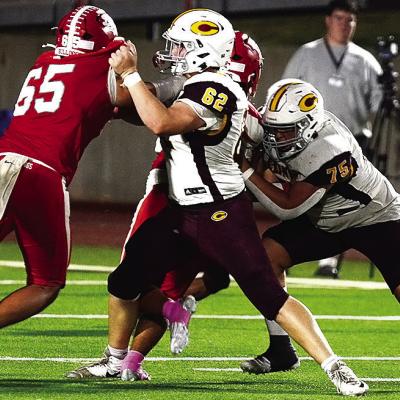 Clinton’s No. 62 Layne Spitz and No. 75 Eli Anderson block Cache defenders during the Red Tornadoes’ road game Thursday against the Bulldogs. CDN | Micah Ashcraft