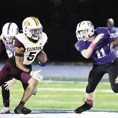 Clinton’s No. 81 Judd Hall and No. 6 Benton Bridgeman provide key blocks to help spring Jesus Gutierrez and allow him to carry the ball for a big gain Friday against Bridge Creek. CDN | John Kinsey