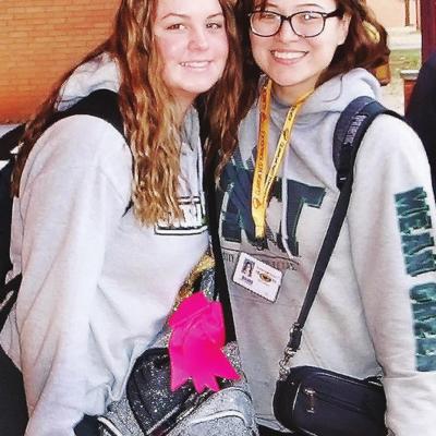 Clinton High School band students Baylee Hawthorne, left, and Ashley Martinez stop for a photo between classes. Pausing to smile