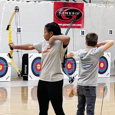 Clinton Middle School students Arlena Kirkendoll, left, and Rustyn Evans prepare to fire their arrows downrange during a NASP archery tournament. CDN | Courtesy photo Archers continue to hit their marks