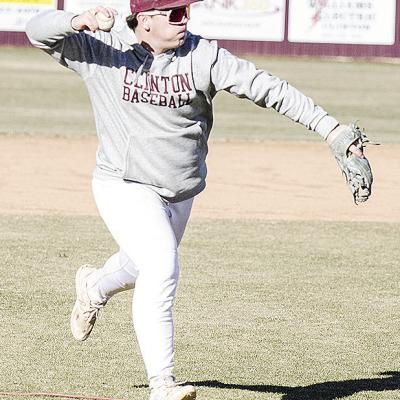 CDN | Sam Goodwyn Clinton’s Trason Lustfield hurls the ball to first for the out during practice at the baseball field.