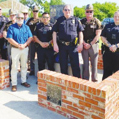 Local and area law enforcement were at Acme Park Monday to commemorate Police Week. From left are Sgt. Peter Porcher, Trooper Pate Gossen, Undersheriff David Crabtree, Sheriff Dan Day, Lt. Aaron Hunter, Officer Emanuel Ruiz, Chief Paul Rinkel, Trooper Tra Police Week is recognized here