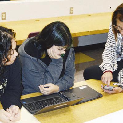 From left, Claudia Gallegos and Gisselle Perez listen as Lynne Walker with GEAR UP, walks them through the sign-in process at Clinton High School. CDN | Michael Maresh From left, Claudia Gallegos and Gisselle Perez listen as Lynne Walker with GEAR UP, walks them through the sign-in process at Clinton High School. CDN | Michael Maresh