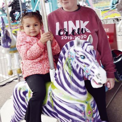 Ellie Gutierrez, left, enjoys the carousel Thursday night at the Spring Carnival, as Makayden Thompson supervises. CDN | Michael Maresh Ellie Gutierrez, left, enjoys the carousel Thursday night at the Spring Carnival, as Makayden Thompson supervises. CDN | Michael Maresh