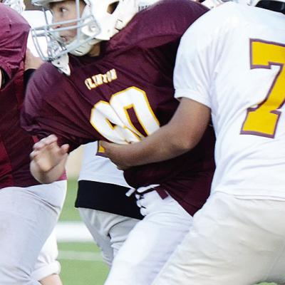 Braxtyn Taylor fights through Chase Spottedwolf’s block during their Clinton NEXT League football game Tuesday at the Tornado Bowl. CDN |Sam Goodwyn