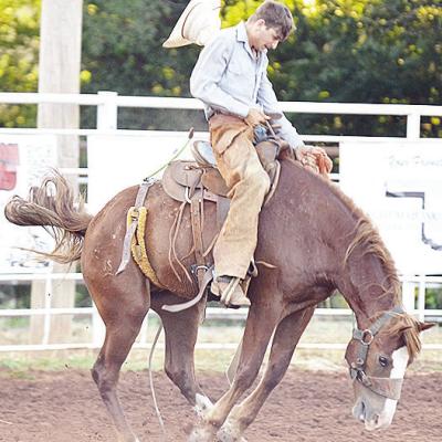 Wyatt Graves holds onto his horse as he loses his hat in the saddle bronc riding event Saturday during the Clinton Roundup Club’s 78th Annual Rodeo. CDN | Sam Goodwyn