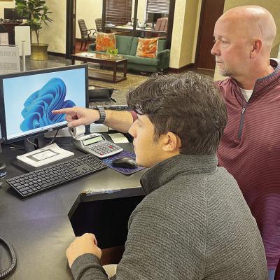 Intern Sutton Hernandez, left, observes as Chris Jones from Bank 360 guides him through several certification learning modules. CDN | Shiann Dawson Intern Sutton Hernandez, left, observes as Chris Jones from Bank 360 guides him through several certification learning modules. CDN | Shiann Dawson