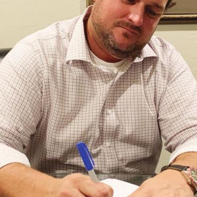 Russ Meacham figures a tax return for a client. Accounting firm prospering