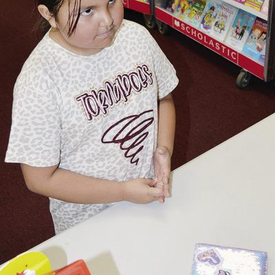 Second-grader Ryann Tapaha gets ready to purchase a journal at the Southwest Elementary Book Fair. CDN | Michael Maresh Second-grader Ryann Tapaha gets ready to purchase a journal at the Southwest Elementary Book Fair. CDN | Michael Maresh