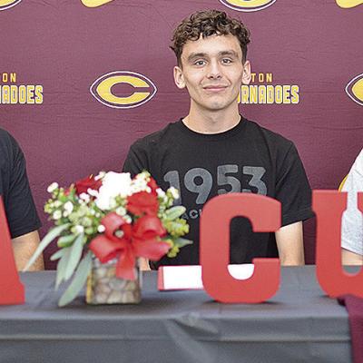 Clinton’s Xadrian Hernandez, center, celebrates Friday with his stepfather Rocky Rodriquez, left, and mother Crystal Munsey Rodriquez, right, after signing to run for Mid-America Christian University track and field, and cross country teams next year. C Clinton’s Xadrian Hernandez, center, celebrates Friday with his stepfather Rocky Rodriquez, left, and mother Crystal Munsey Rodriquez, right, after signing to run for Mid-America Christian University track and field, and cross country teams next year. C