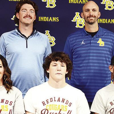 Arapaho-Butler’s Rylan Moore, center, celebrates signing to play baseball for Redlands college in El Reno. Pictured in front, from left, are his mom Meagan Moore, and his dad Joey Moore; back, Coach Chase Johnson and Coach Bryan Holt. CDN | Sam Goodwyn