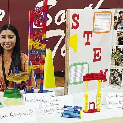 Joanna Venegas shows off several student STEM-based projects to better convey the value in the Clinton Public School’s REDS 365 program to community members at Southwest Elementary. CDN | Courtesy photo