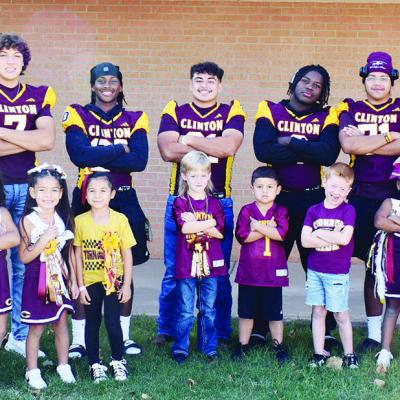 Nance Elementary students, front from left, Lydia Labastida, Adelynn Marquez, Betsy Tellez Fonseca, Maverick Coxwell, Adolfo Soto, Owen Stockton, Natalie Gresham, Audi Gutierrez, and CHS trainer Angelina Ramirez are backed up by football players Wyatt Wil Clinton school pride