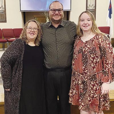 Jamie Patton, center, smiles with his wife Kelli, left, and daughter Carli after being selected as the new pastor at New Hope Fellowship Church. CDN | Courtesy photo