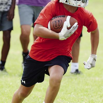 BentLee Potter carries the ball during the first day of football practice for the Whirlwinds Monday at Clinton Middle School. CDN | Sam Goodwyn