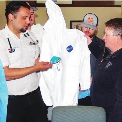 Sinor EMS first responders evaluating protective gear during a COVID-19 training are, from left, Tana Porter, EMT Basic; Jeremy Pool, paramedic; James Livingston, EMR (partially hidden); Jordan Magee, EMT; Michelle Addington, EMS director; Nathan McPherso Sinor EMS learns how to take Coronavirus precautions