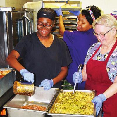 Clinton Public Schools’ “cafeteria ladies,” from left, Clinton Middle School head cook Sandra Jackson, Lana Golden and Holli Lowrey prepare for the Spring Feed program to be held during spring break next week. 11 a.m. until 1 p.m. Monday through Fri Spring Feed set for next week