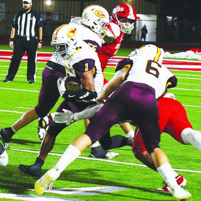 Clinton’s No. 6 Benton Bridgeman and No. 55 Bryson Snider provide key blocks for No. 1 Derren Hester as he carries the ball up the field during the Red Tornadoes’ road game Thursday against Cache. CDN | Micah Ashcraft