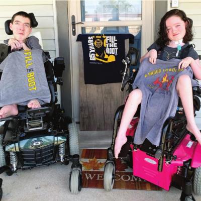 Siblings Joshua, left, and Emery Sorter show off some of their Fill the Boot T-shirts from past years. Joshua, a junior at Clinton High School, and Emery, a third grader, have congenital muscular dystrophy. Annual Fill the Boot to be held this weekend