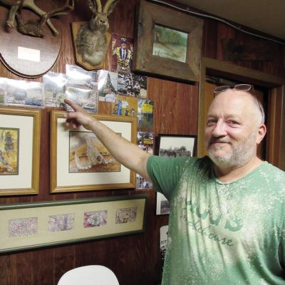 Jigg’s Smokehouse owner Lynn Klaassen points to one of the many photos scattered throughout the restaurant, which is now up for sale. CDN | Angela Nichols Long legacy