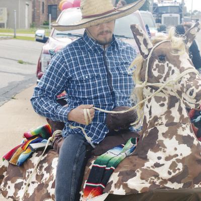 Alan Torres rides what appears at first glance a horse. The “horse” is powered by human legs underneath where Torres is “sitting.” CDN | Michael Maresh