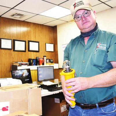 Scott Moore, owner of Williams Electric, takes out a clear LED runaway light from a box that will be placed at an airport location. CDN | Litzy Silos Williams Electric is go-to for airports