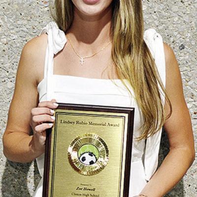 Clinton’s Zoe Howell is all smiles as she proudly holds up her Lindsey Rubio Memorial Award after the annual soccer banquet Sunday at the Frisco Center. CDN | Sam Goodwyn Clinton’s Zoe Howell is all smiles as she proudly holds up her Lindsey Rubio Memorial Award after the annual soccer banquet Sunday at the Frisco Center. CDN | Sam Goodwyn