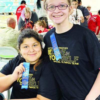 Winter Lee, left, and Raylei Harrell show off their first-place ribbons, after representing the Clinton Red Tornado Special Olympics Team at a regional bowling contest in Lawton. CDN | Courtesy photo