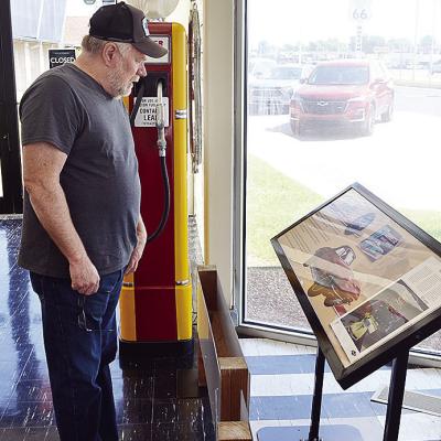 Dave Ketchum from St. Louis, Mo., examines the Corvette display Wednesday at the front of the Oklahoma Route 66 Museum. CDN | Sam Goodwyn