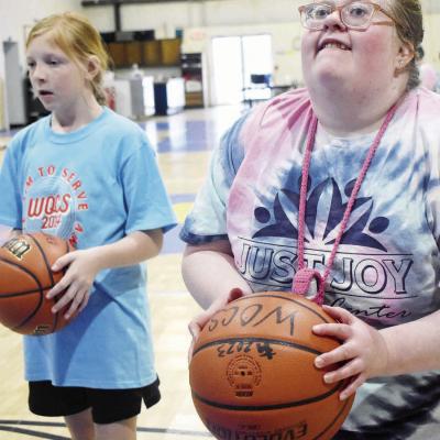 Western Oklahoma Christan School fifth grader Ellie Schmidt, left, and Justice Carman from Just Joy engage in a spirited game of one-on-one basketball. CDN | Elisha Rangel Taking big aim