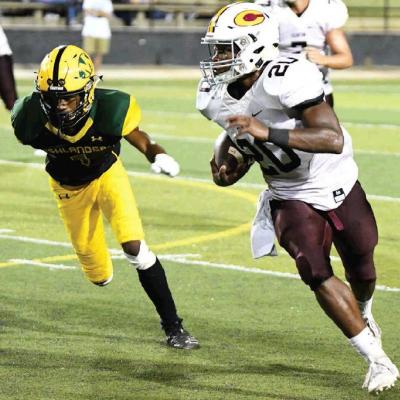 CDN | John Kinsey Clinton running back Atrel Bryson, No. 20, gets to the edge and zooms by a Lawton MacArthur defender for a big gain. Article Image Alt Text