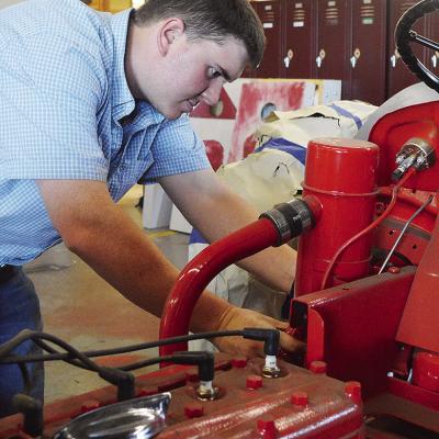 Ethan Hyers checks his students’ work on a tractor project at the Clinton High School Ag Shop. CDN | Micah Ashcraft Ethan Hyers checks his students’ work on a tractor project at the Clinton High School Ag Shop. CDN | Micah Ashcraft
