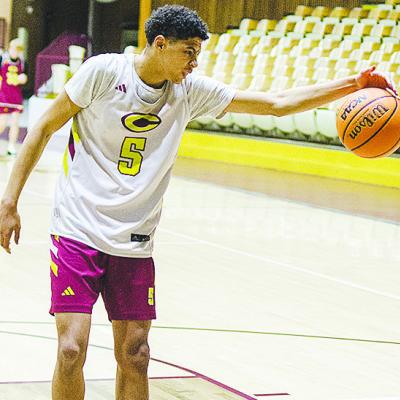 Clinton’s Kyron Forrest grabs the ball before it gets away from him during practice in the Tornado Dome. CDN | Sam Goodwyn
