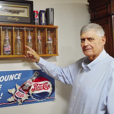 Clinton Chamber of Commerce Chair Mark Nicholson shows off his Pepsithemed glasses and memorabilia in his office at the Pepsi Bottling Group. CDN | Micah Ashcraft Clinton Chamber of Commerce Chair Mark Nicholson shows off his Pepsithemed glasses and memorabilia in his office at the Pepsi Bottling Group. CDN | Micah Ashcraft