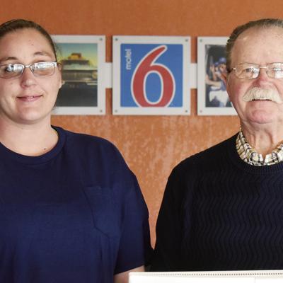 General Manager Michelle Dawson, left, and new owner Larry Whitten stand at the front desk of the Motel 6 at 2247 W. Gary Blvd. CDN | Caleb Blanchard Hotel operator returns to town to take over Motel 6