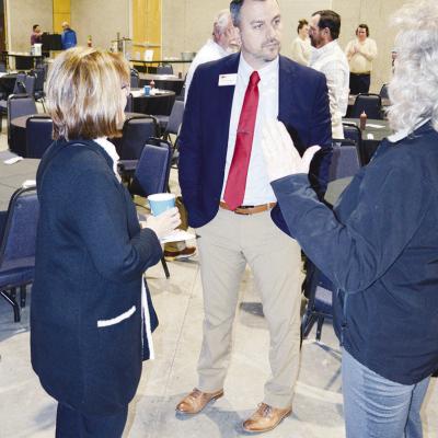 Sarah Hirschman, right, from Western Technology Center, speaks to Clinton Supt. Tyler Bridges, middle, while WTC Supt. Kathe Corning listens. CDN | Michael Maresh