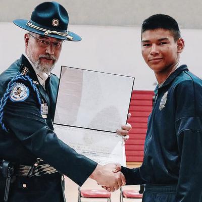Deputy Director of the Bureau of Indian Affairs Glen Melville, left, presents soon to be Clinton High School freshman Nevin Hines his certificate for graduating through the Bureau of Indian Affairs’ Youth Police Academy program at the Riverside Indian S