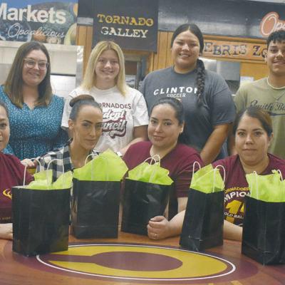 Front row, from left, Maria Garcia, Kayla Walker, Yennifer Saldana, Edit Juarez and Natalie Espinoza pose with goodie bags for School Lunch Hero Day. Back row are Assistant Principal Brent Caldwell, STUCO sponsor Brittany Miller, Senior Class Treasurer Ka Students honor lunch heroes