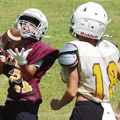 Clinton’s BentLee Potter, left, catches the ball right in front of Chance Roper during practice at the Middle School. CDN | Sam Goodwyn