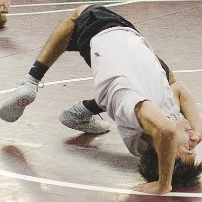 Brandon Rodriguez-Escalante bridges off his back during wrestling practice. CDN | Sam Goodwyn