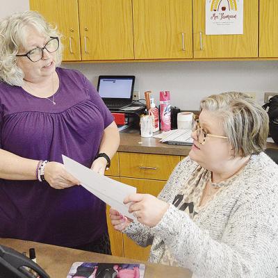 Patti Esparza, left, and Michelle Thompson check on school Tshirt orders while at the front desk at Washington Elementary School. CDN | Micah Ashcraft Patti Esparza, left, and Michelle Thompson check on school Tshirt orders while at the front desk at Washington Elementary School. CDN | Micah Ashcraft